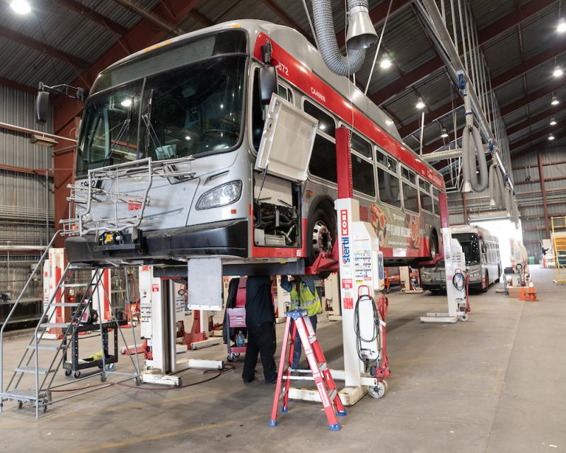 Bus on a lift at 1399 Marin St.