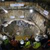 Project and agency staff watch TBM Big Alma emerge inside the North Beach retrieval shaft in 2014.