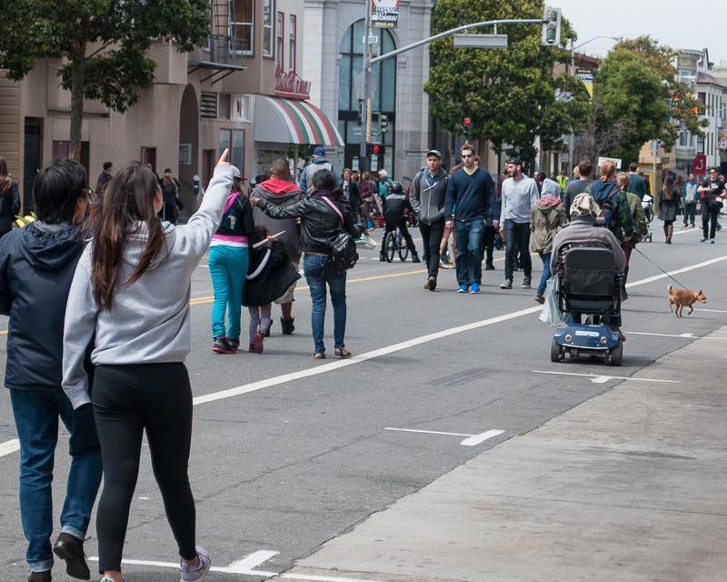 people walking down valencia closed for sunday streets event