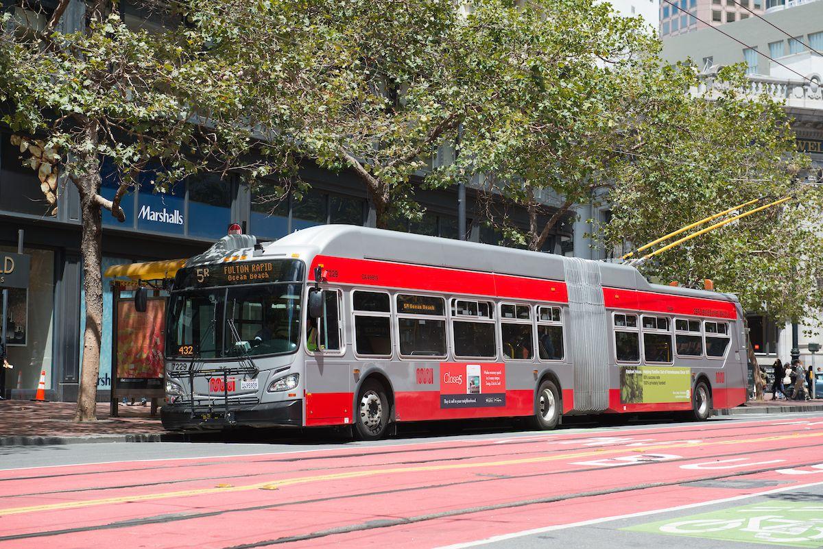 A photograph of the 5 Fulton on Market Street in downtown San Francisco, next to a red bus rapid transit lane.