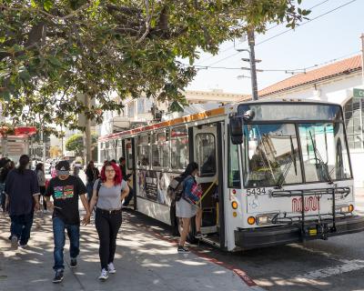 high school students boarding muni bus on 18th and church