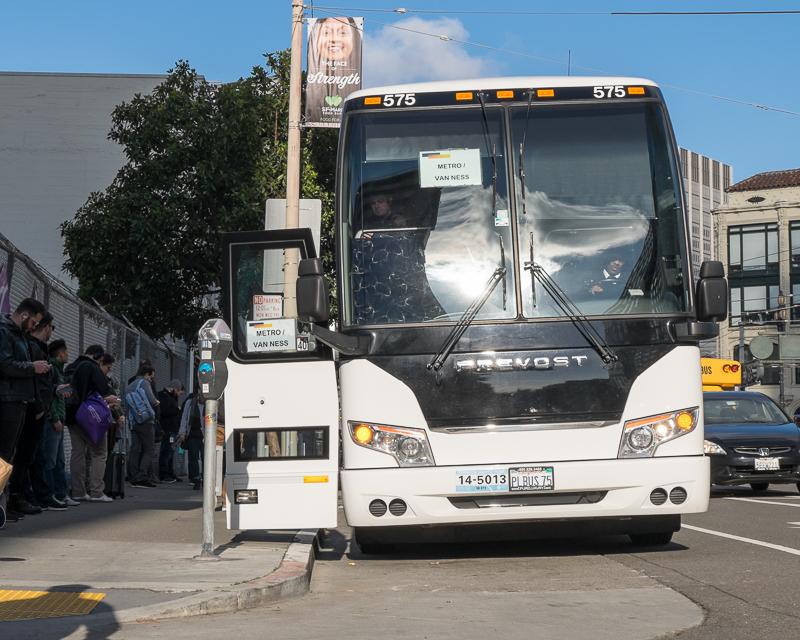 white double-decker commuter shuttle bus on 8th and market streets