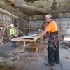 A carpenter builds part of a concrete form in the northwest corner of the YBM station headhouse.