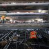 A worker walks atop the rebar cage of the invert slab at the north end of the Union Square/Market Street station box.