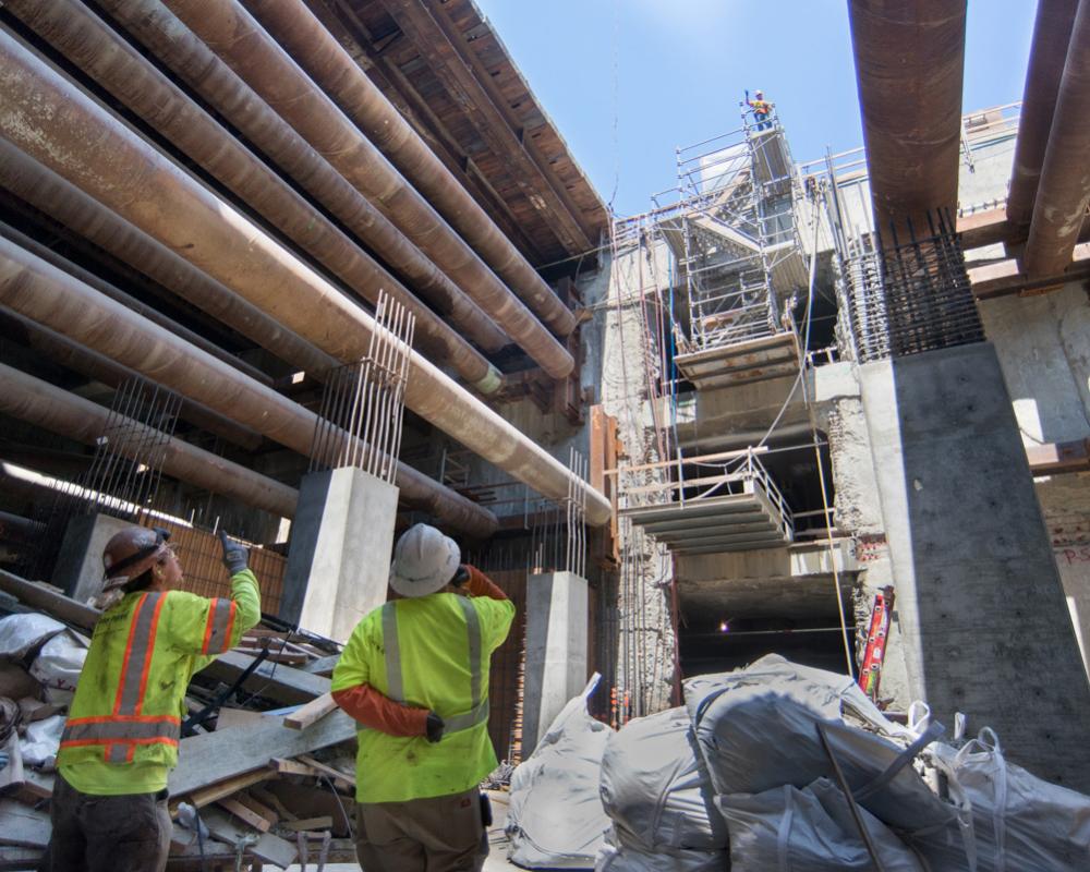 Workers signal from the bottom of the Yerba Buena/Moscone Station headhouse to the surface.