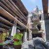 Workers signal from the bottom of the Yerba Buena/Moscone Station headhouse to the surface.