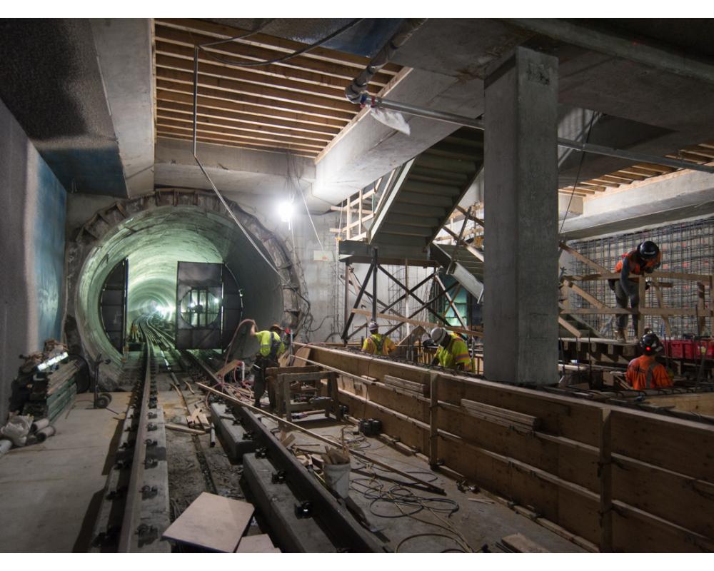 Workers construct final structural elements of the Yerba Buena/Moscone station platform.