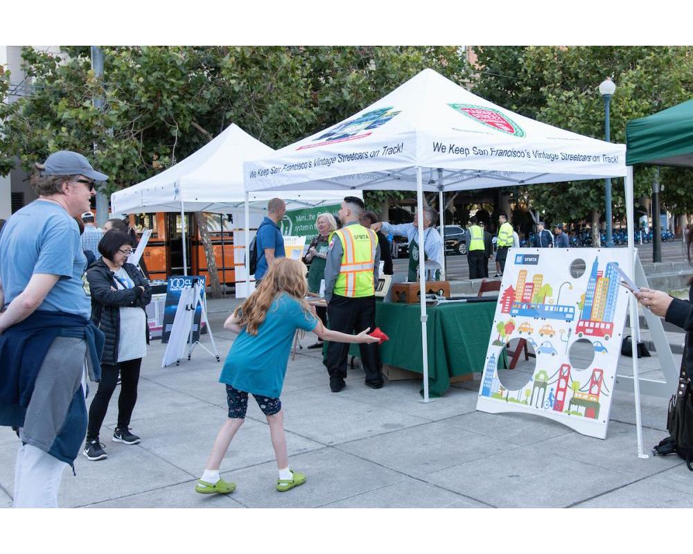 Community member plays a game at an SFMTA public outreach event.