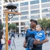 Child rings a bell at community event.