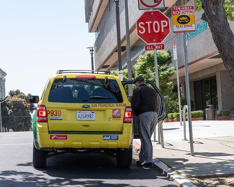 A person boards a taxi