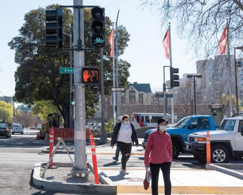 Image shows pedestrians walking across Geary Boulevard