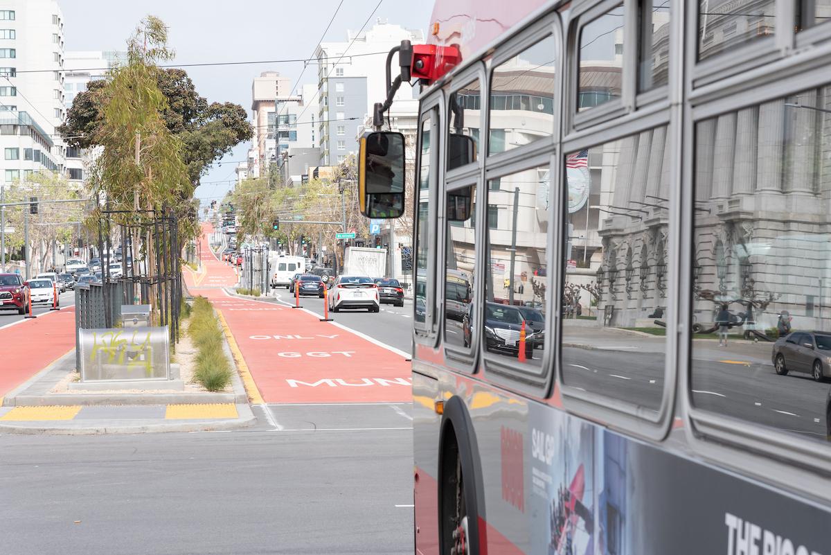 Closeup of a 49 Van Ness bus as it approaches a red, transit-only lane on Van Ness Avenue.