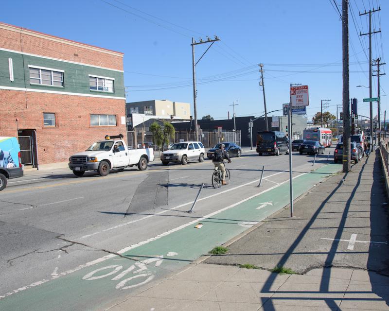 Existing bike lane on Cesar Chavez east of Evans, bike in vehicle lane , vehicles parked in bike lane