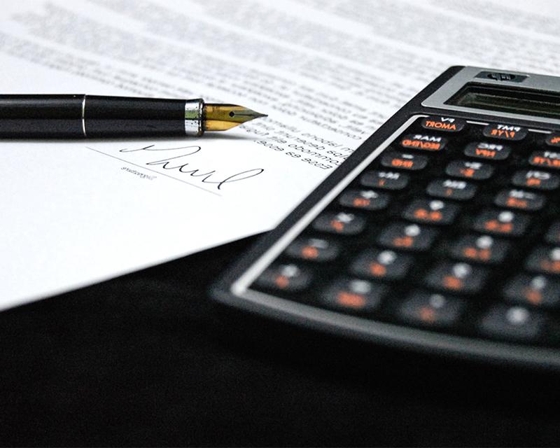 Photo of calculator, paper and pen