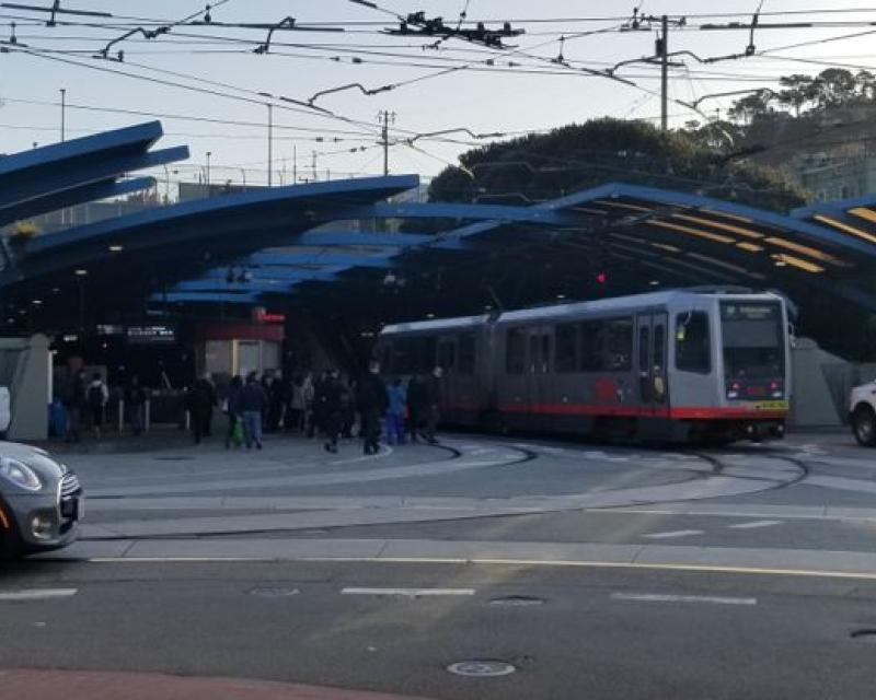 A busy morning for pedestrians, cars and trains at West Portal