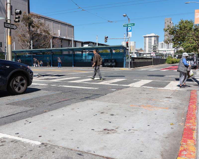 Curb painted red near an intersection to provide "daylight" and better visibility for pedestrians cross street