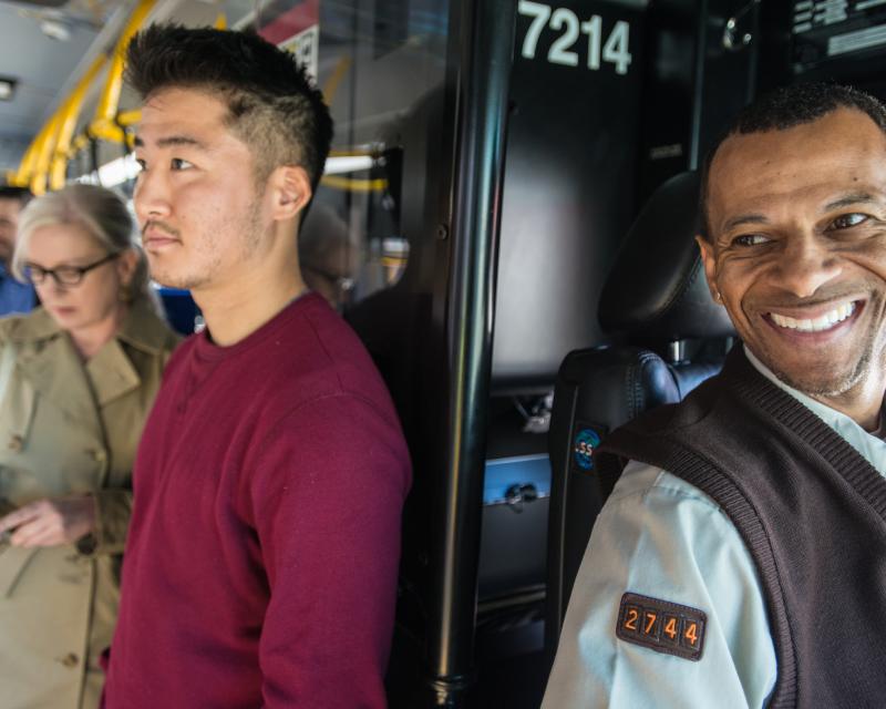 Photo of Muni operator and passengers in background