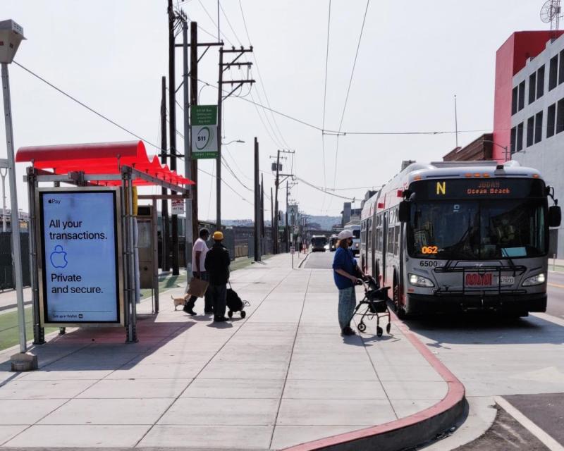 Customers boarding Muni bus on newly built sidewalk loading island on Townsend Street.