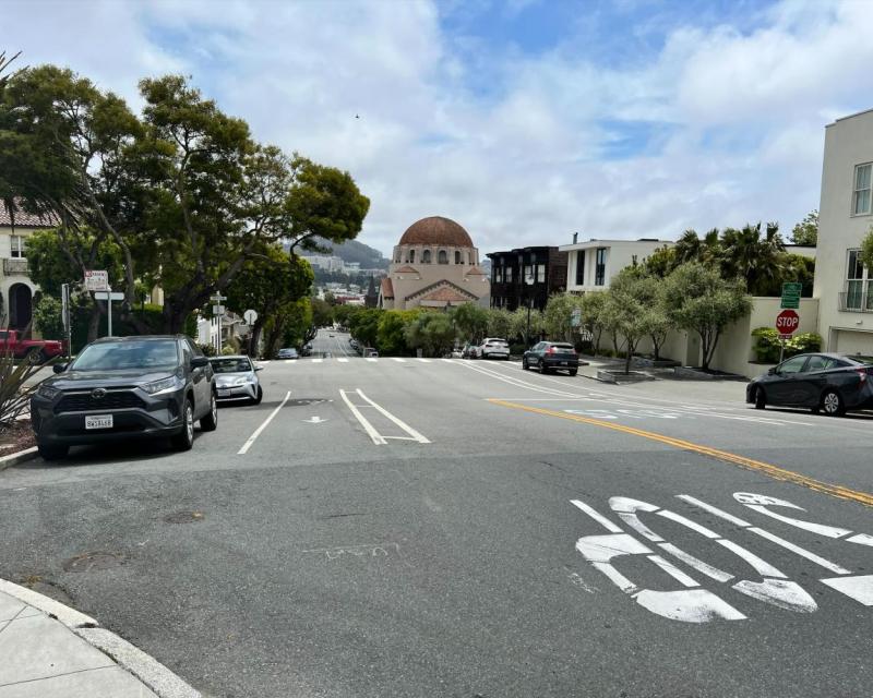 Street view of Arguello Boulevard with cars parked on either side.