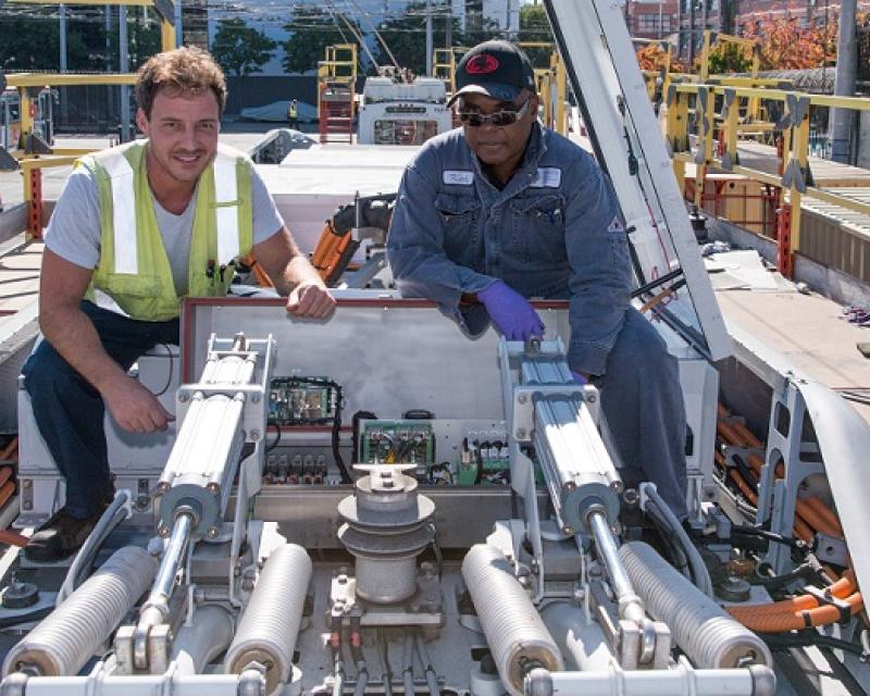 Men working on a bus in our maintenance yard.