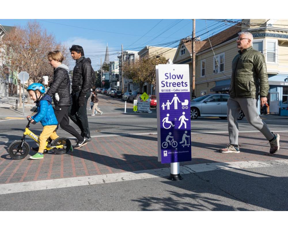 People crossing Slow Sanchez Street