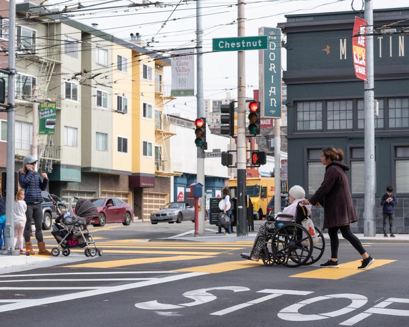 Woman pushes woman in wheelchair on Chestnut Street