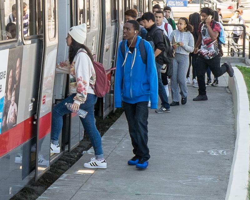 teen boarding Muni train