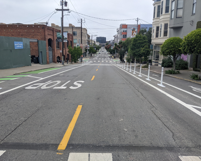 View looking east on 17th Street at Vermont Street showing the completed quick-build project, including delineator-separated bike lanes on each side of the street